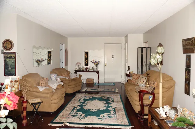a living room with furniture rug and wall painting