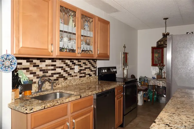 a kitchen with a sink stove and refrigerator