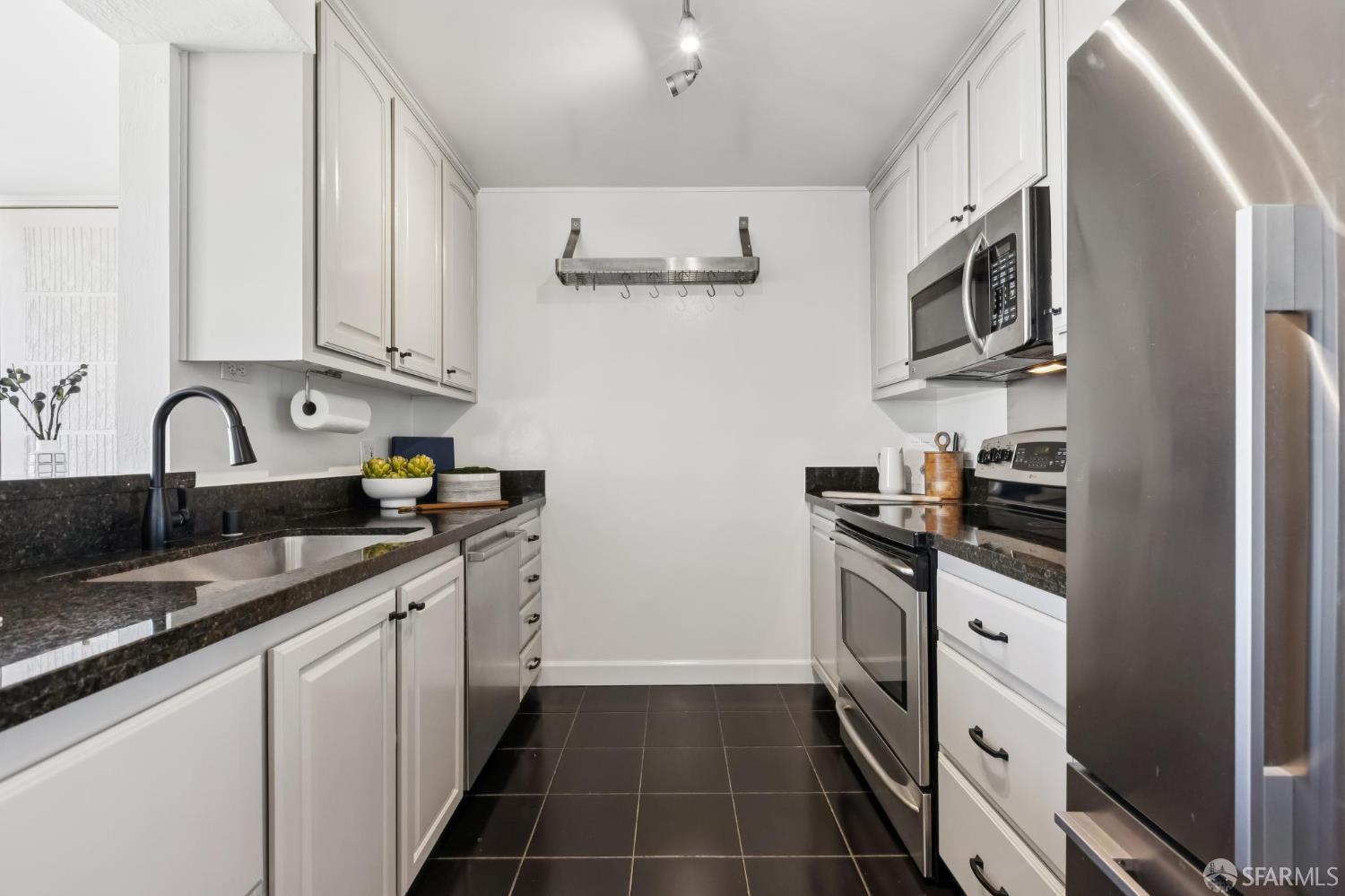 150 Lombard Street, Unit 807 San Francisco, CA 94111 - Photo 29 of 68 a kitchen with stainless steel appliances granite countertop a sink and cabinets