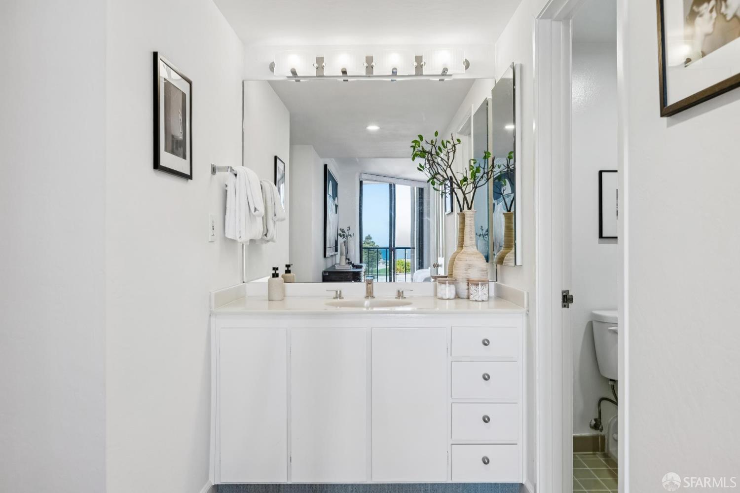 150 Lombard Street, Unit 807 San Francisco, CA 94111 - Photo 36 of 68 a bathroom with a double vanity sink and a mirror