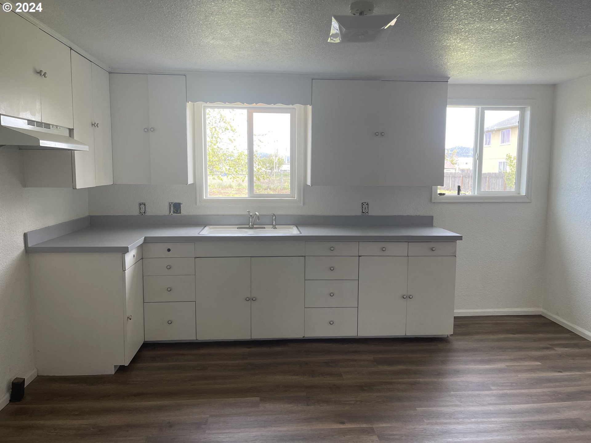 4530 Aster Street Springfield, OR 97478 - Photo 7 of 10 a kitchen with granite countertop white cabinets and a sink