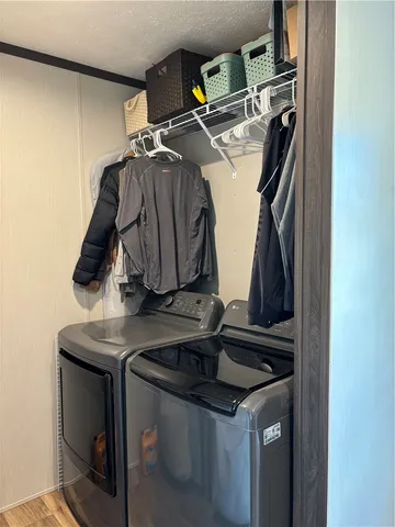 a swimming pool view with a big yard and large trees