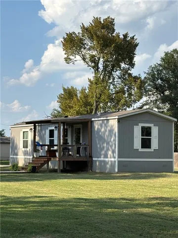 a front view of a house with swimming pool having outdoor seating