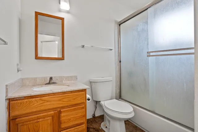 a bathroom with a sink toilet and vanity