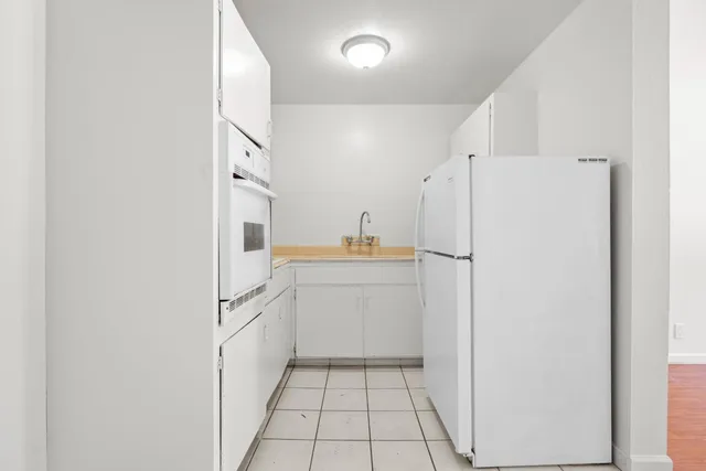a kitchen with a refrigerator and a sink