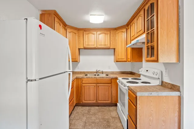 a utility room with closet a stove and a refrigerator