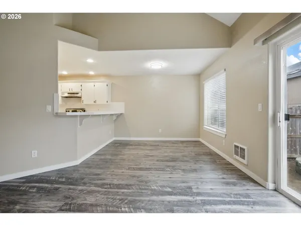 a view of a kitchen with a sink and wooden floor