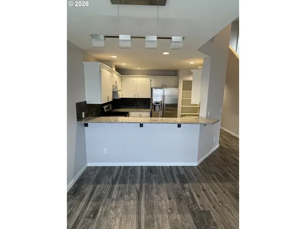a view of a kitchen with a sink and cabinets