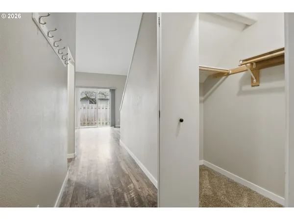 a view of hallway with wooden floor