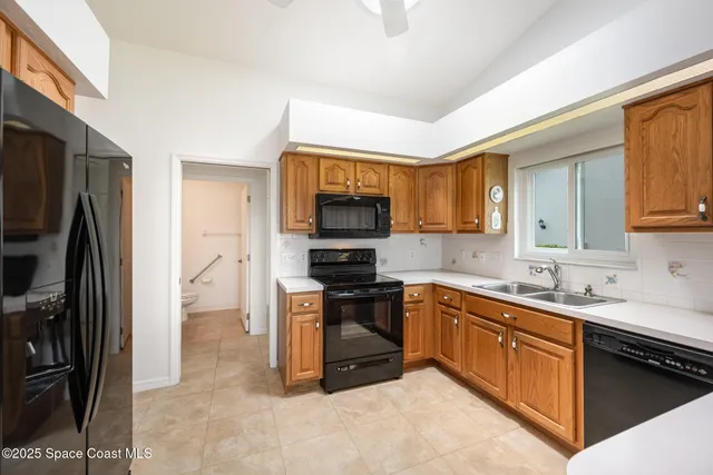 a kitchen with granite countertop stainless steel appliances and wooden cabinets