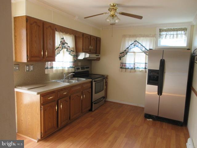 344 Cayots Corner Road Chesapeake City, MD 21915 - Photo 11 of 28 a kitchen with stainless steel appliances granite countertop a refrigerator a sink a stove and wooden floors