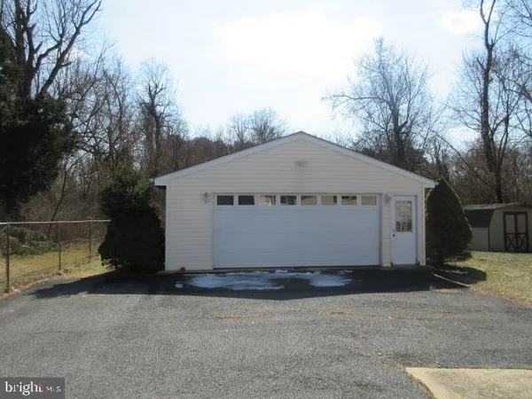 a view of a house with a yard and large tree