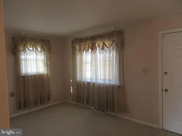 a view of an empty room with windows
