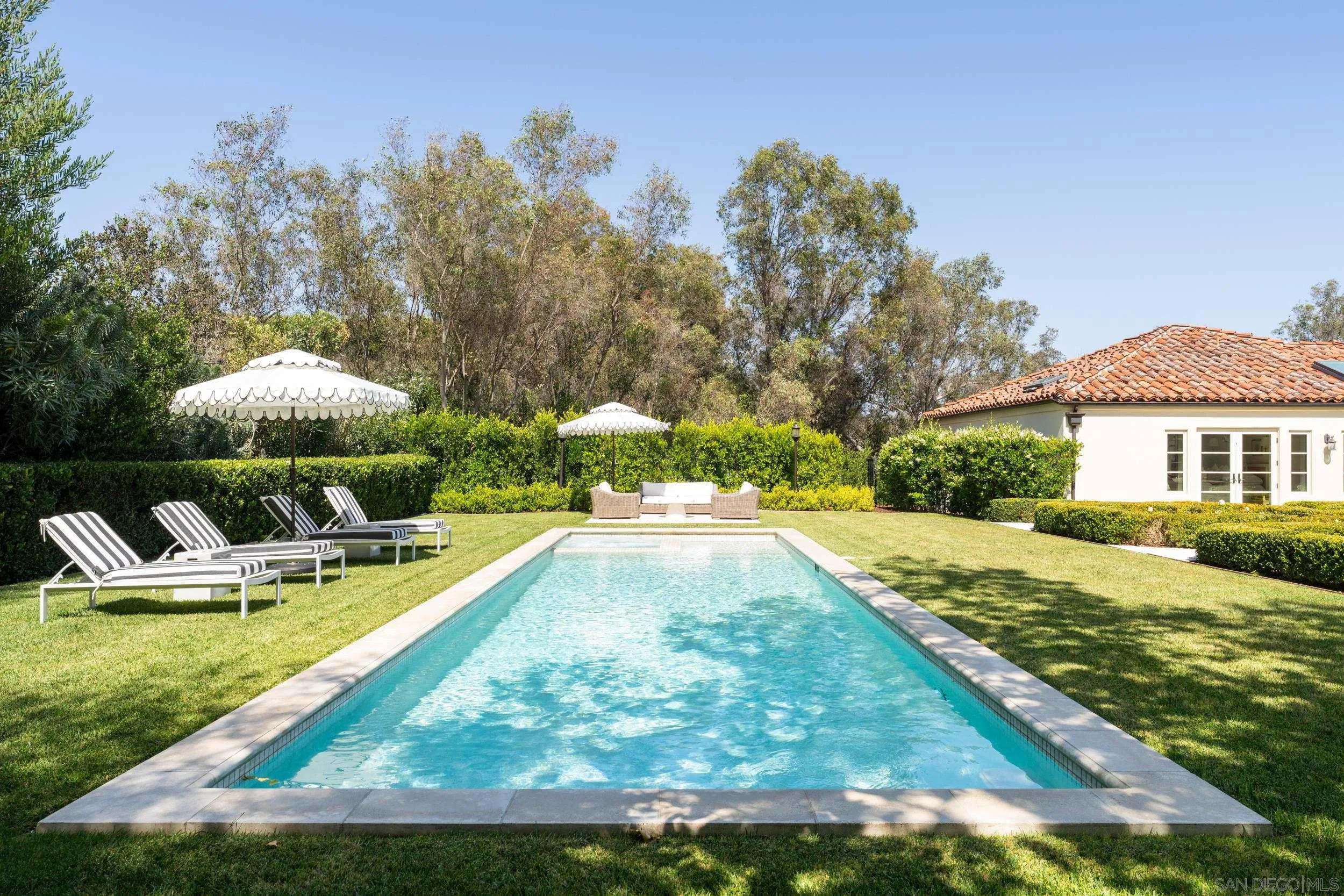 5406 Calzada Del Bosque Rancho Santa Fe, CA 92067 - Photo 21 of 30 a view of a house with swimming pool and sitting area