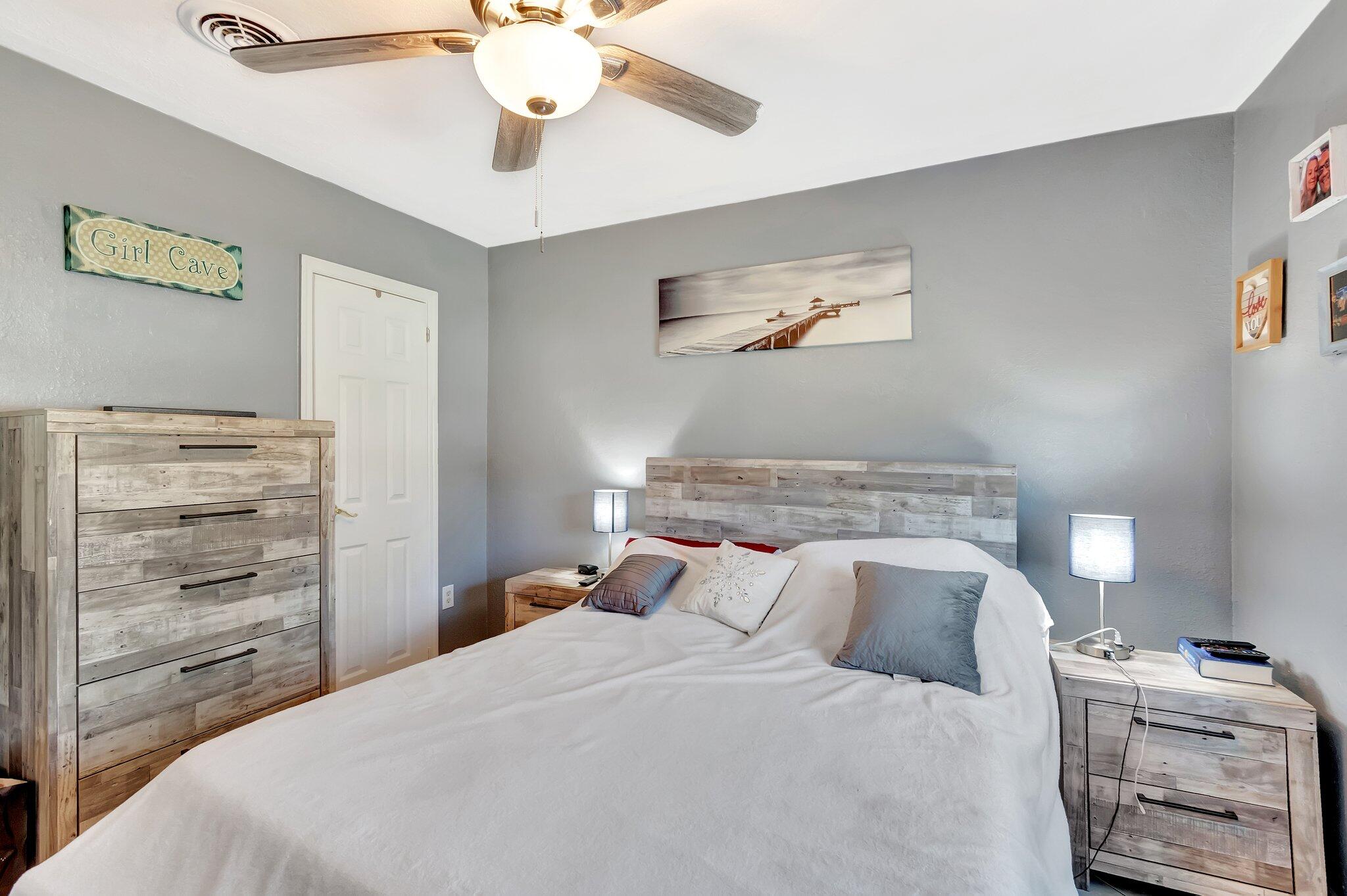 3890 Ocala Road Lake Worth, FL 33462 - Photo 11 of 29 a bedroom with a bed and a chandelier