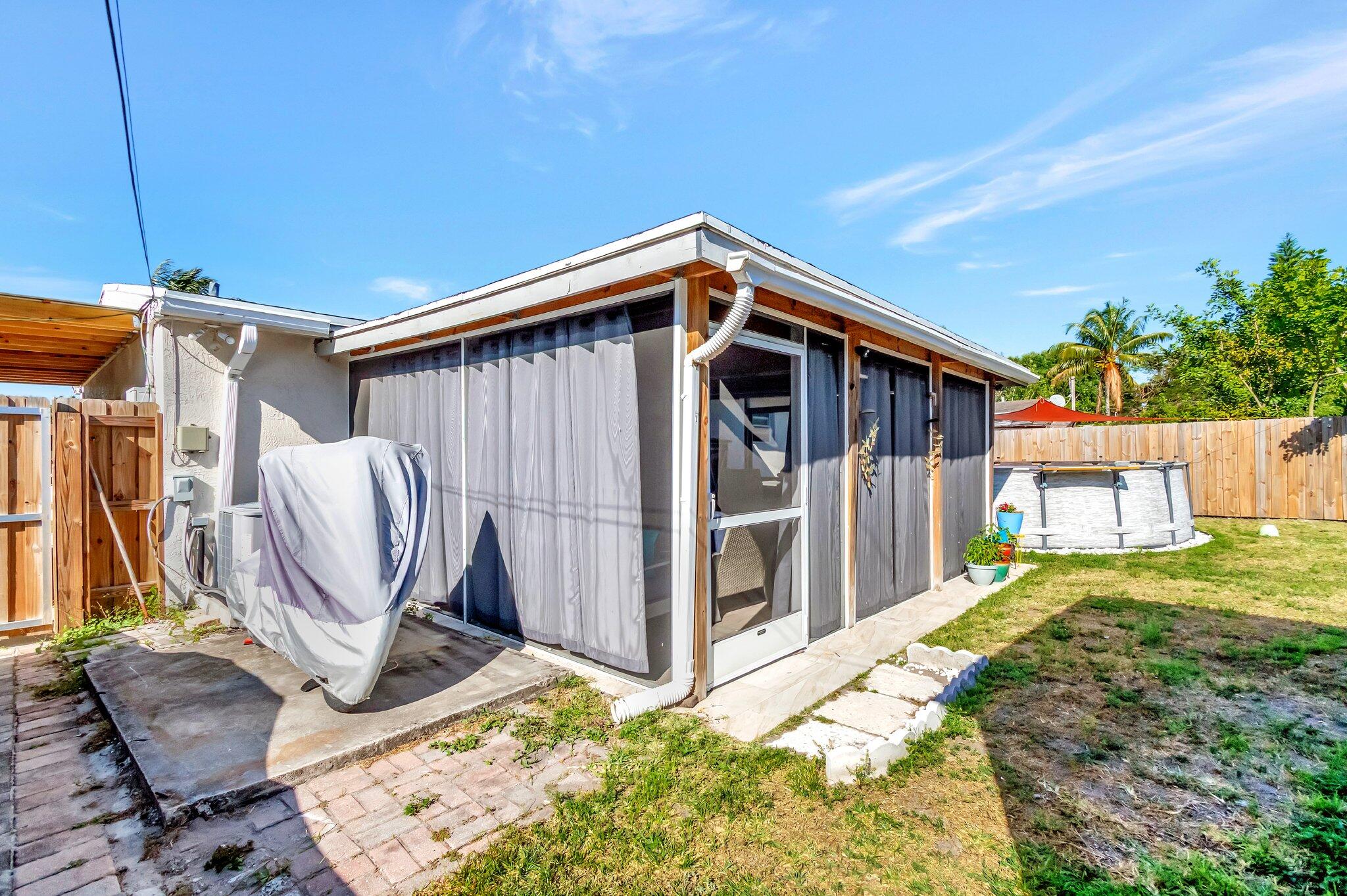 3890 Ocala Road Lake Worth, FL 33462 - Photo 23 of 29 a view of a backyard with chairs and a grill