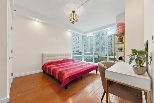 a bedroom with a bed and a table