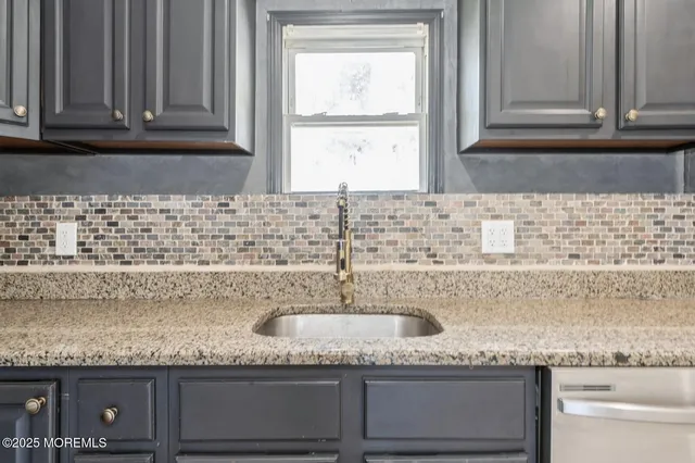 a kitchen with granite countertop a sink and a window