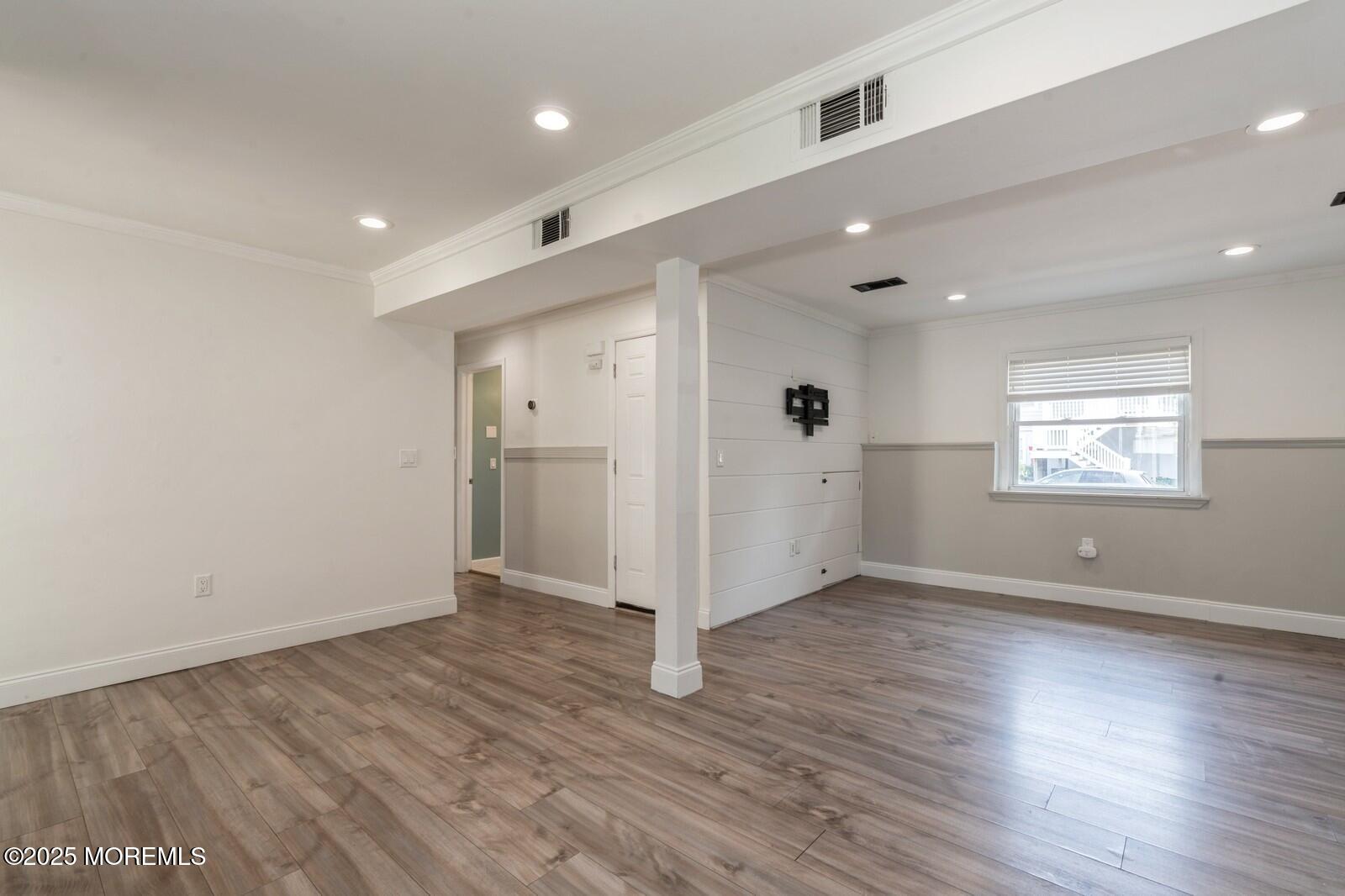 52 Atlantic Street, Unit 2 Highlands, NJ 07732 - Photo 12 of 35 an empty room with wooden floor and windows
