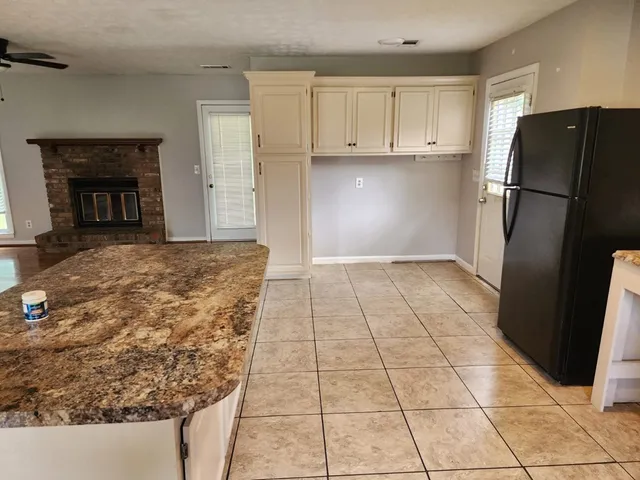 a kitchen with granite countertop a refrigerator and a stove