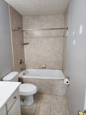 a bathroom with a toilet a sink and shower