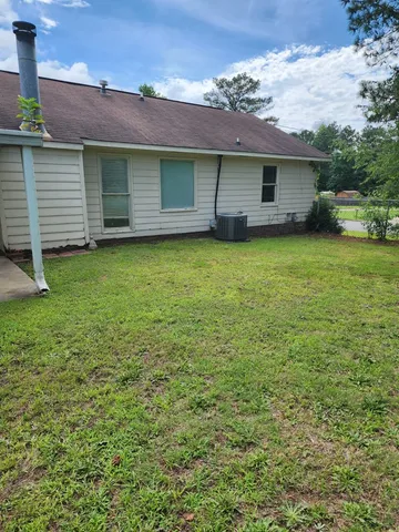a view of a house with a backyard