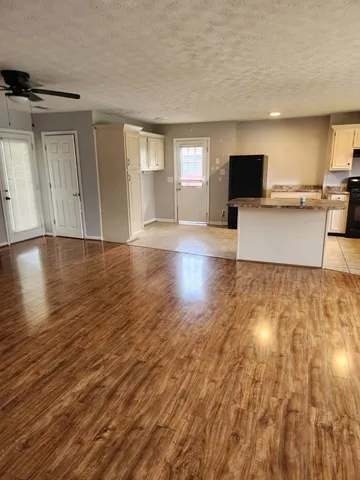 a view of empty room with wooden floor and windows