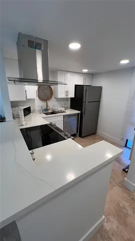 a kitchen with stainless steel appliances a refrigerator sink and stove