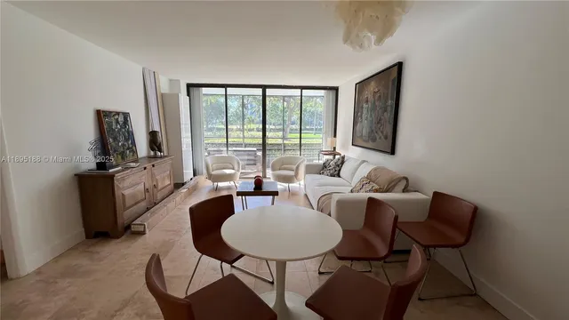 a living room with furniture a rug and a flat screen tv