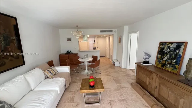 a bedroom with two beds and painting on the wall