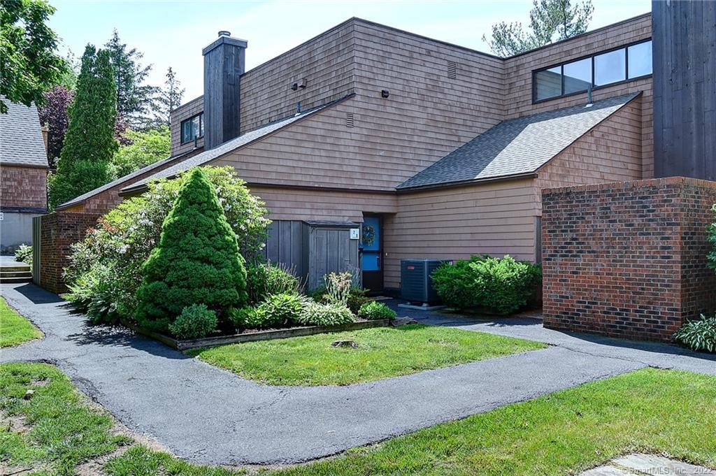 28 Orange Road, Unit 28 Middletown, CT 06457 - Photo 1 of 1 a view of a house with brick walls plants and large tree