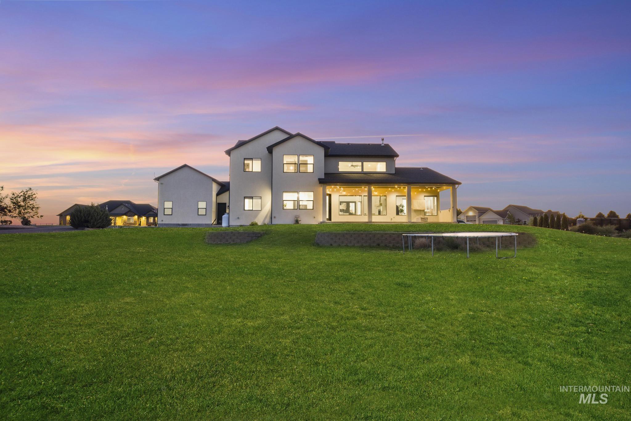 4280 Rim Vista Road Filer, ID 83328 - Photo 46 of 50 Expansive green lawn with a retaining wall, a covered patio, and multi-story stucco exterior