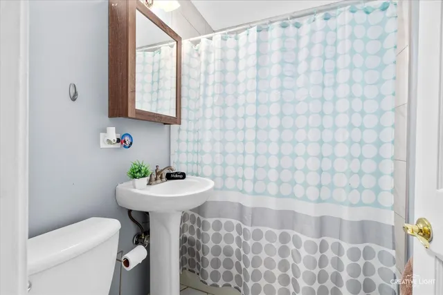 a bathroom with a sink a toilet and mirror