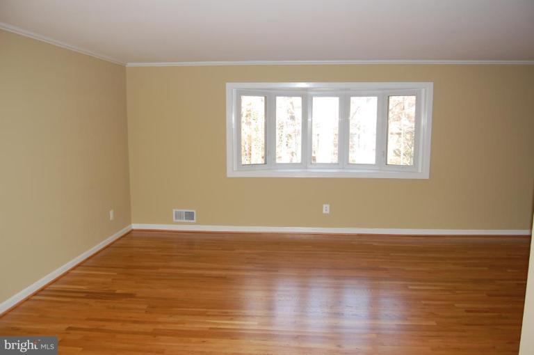 8419 Thames Street Springfield, VA 22151 - Photo 11 of 14 a view of an empty room with wooden floor and a window