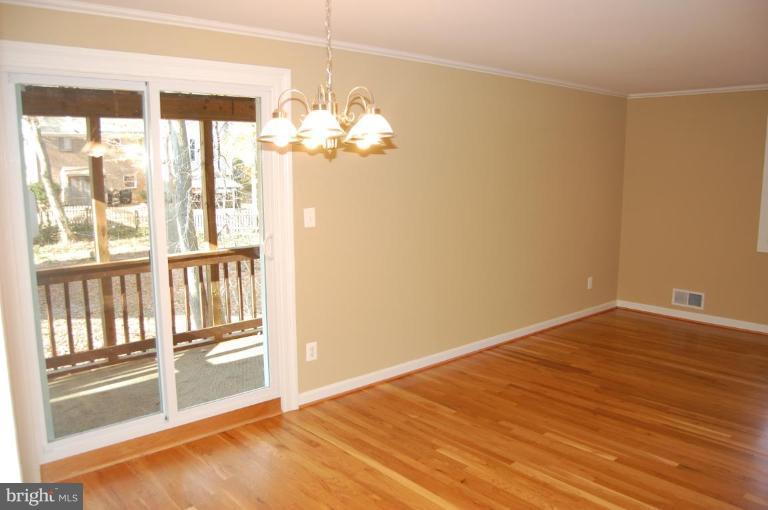 8419 Thames Street Springfield, VA 22151 - Photo 9 of 14 a view of empty room with wooden floor and fan