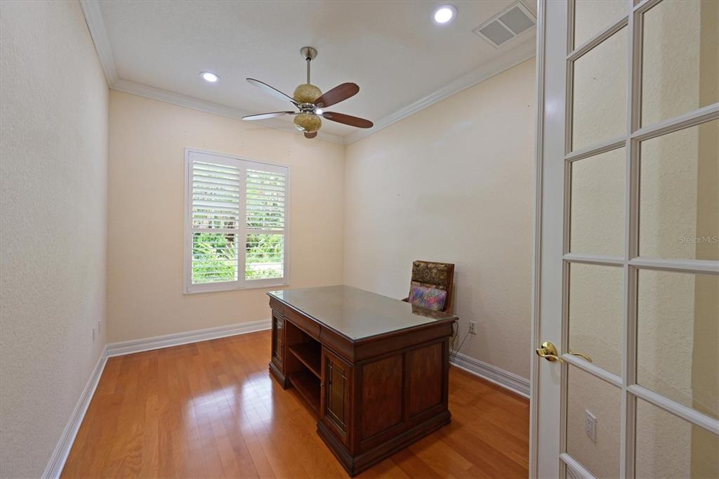 10622 Conch Shell Terrace Bradenton, FL 34212 - Photo 25 of 69 a room with wooden floor and a ceiling fan