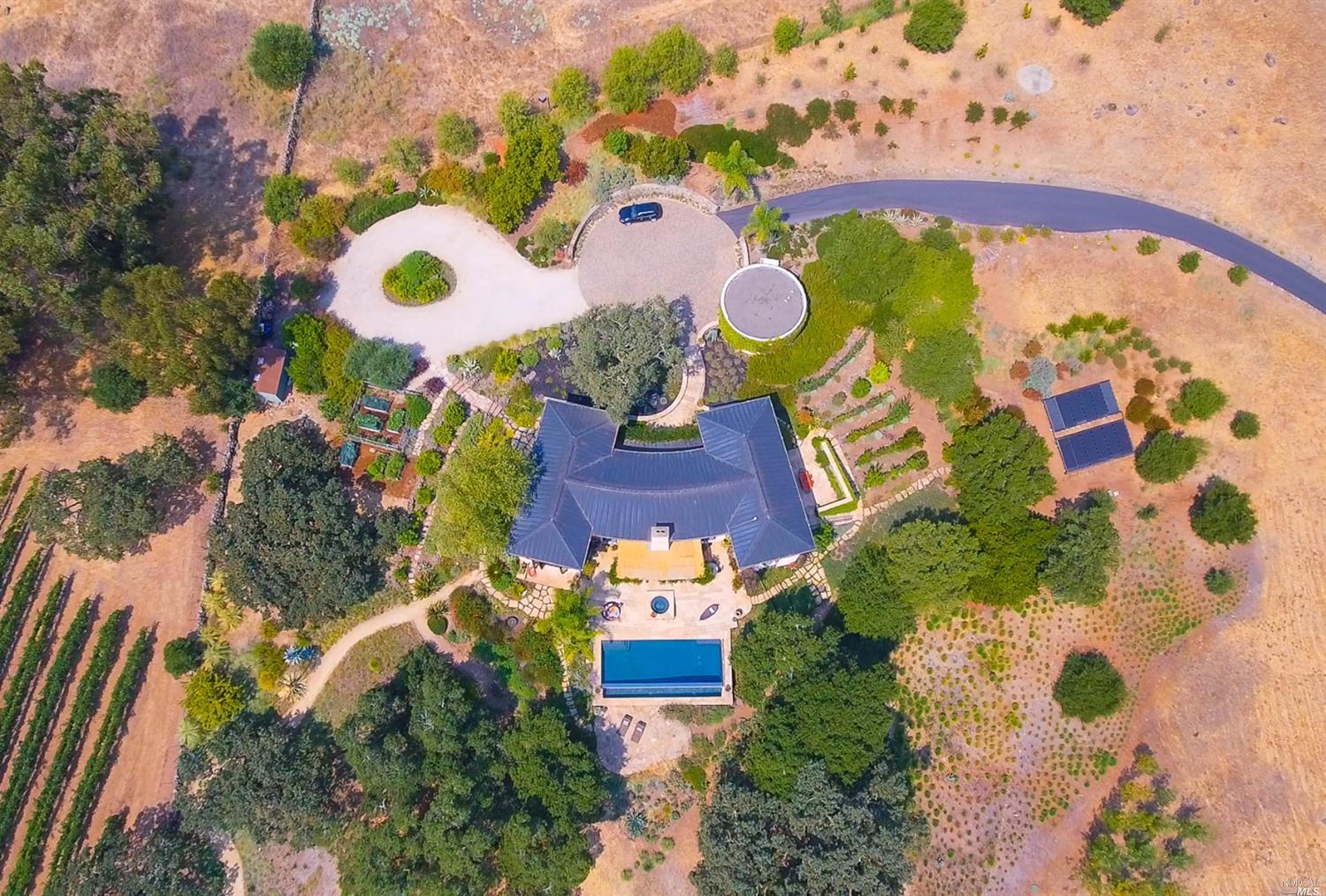 an aerial view of a house a yard and parking