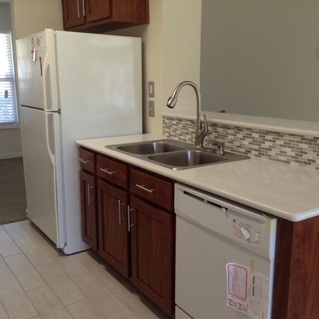 7308 Middlebrook Circle Nashville, TN 37221 - Photo 9 of 20 a kitchen with a sink a refrigerator and cabinets
