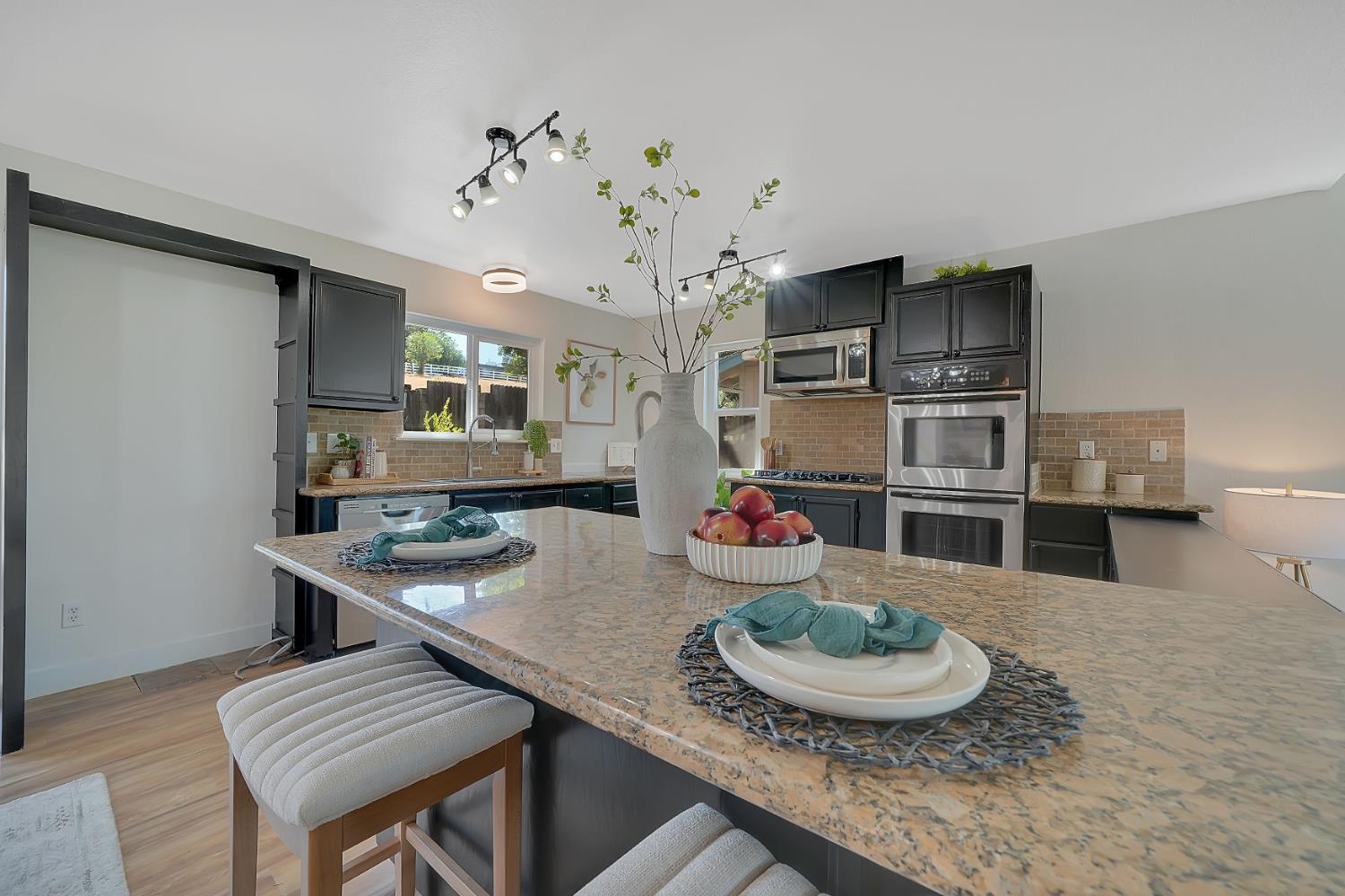 513 Perry Street Jackson, CA 95642 - Photo 13 of 56 a room with stainless steel appliances kitchen island a table and chairs