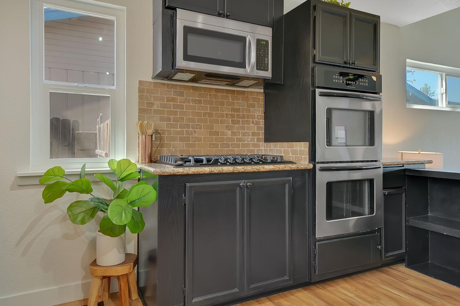 513 Perry Street Jackson, CA 95642 - Photo 15 of 56 a kitchen with stainless steel appliances a stove a microwave and cabinets
