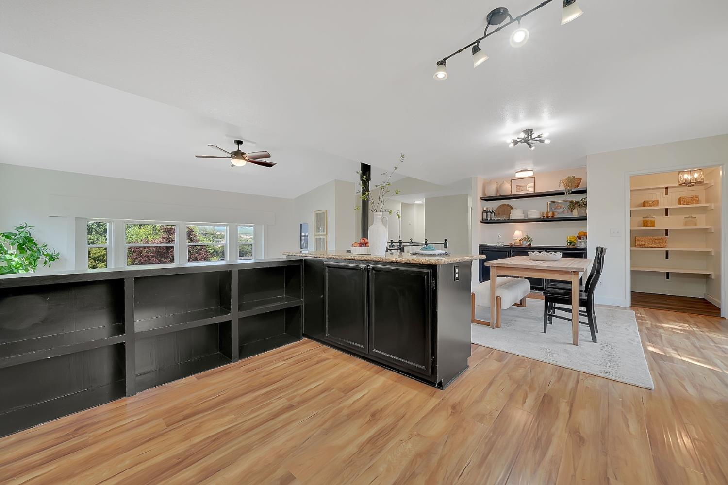 513 Perry Street Jackson, CA 95642 - Photo 17 of 56 a kitchen with a wooden floor and chairs