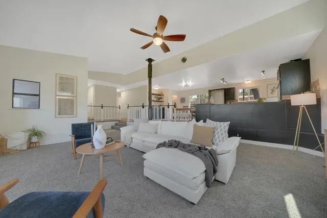 a living room with furniture and kitchen view