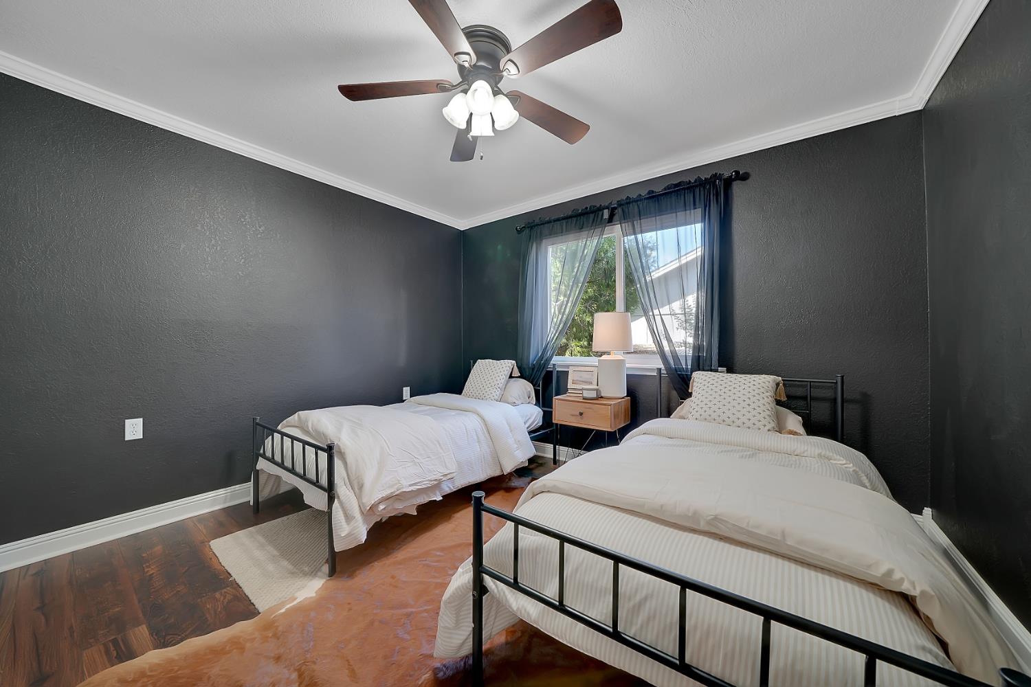 513 Perry Street Jackson, CA 95642 - Photo 33 of 56 a bedroom with two beds and a chandelier