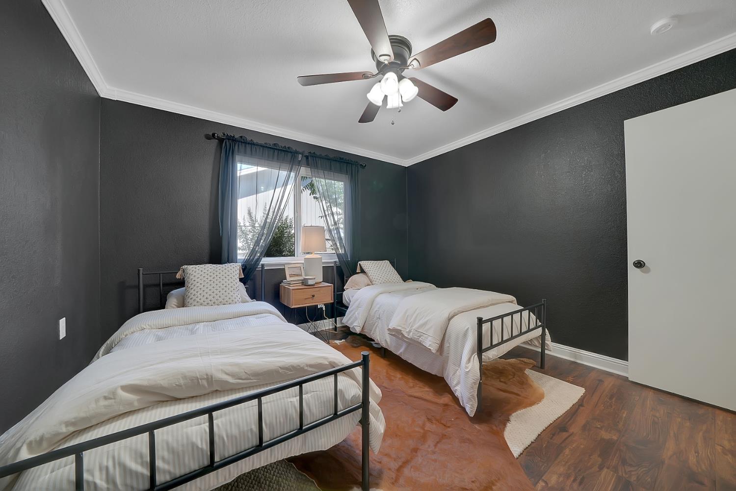 513 Perry Street Jackson, CA 95642 - Photo 34 of 56 a bedroom with two beds and a chandelier