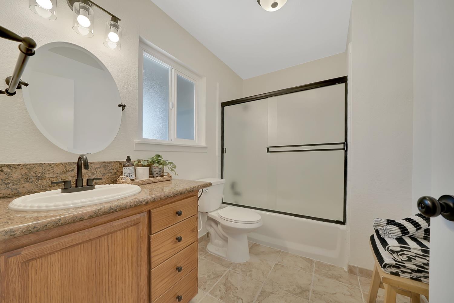 513 Perry Street Jackson, CA 95642 - Photo 35 of 56 a bathroom with a granite countertop sink mirror vanity and toilet