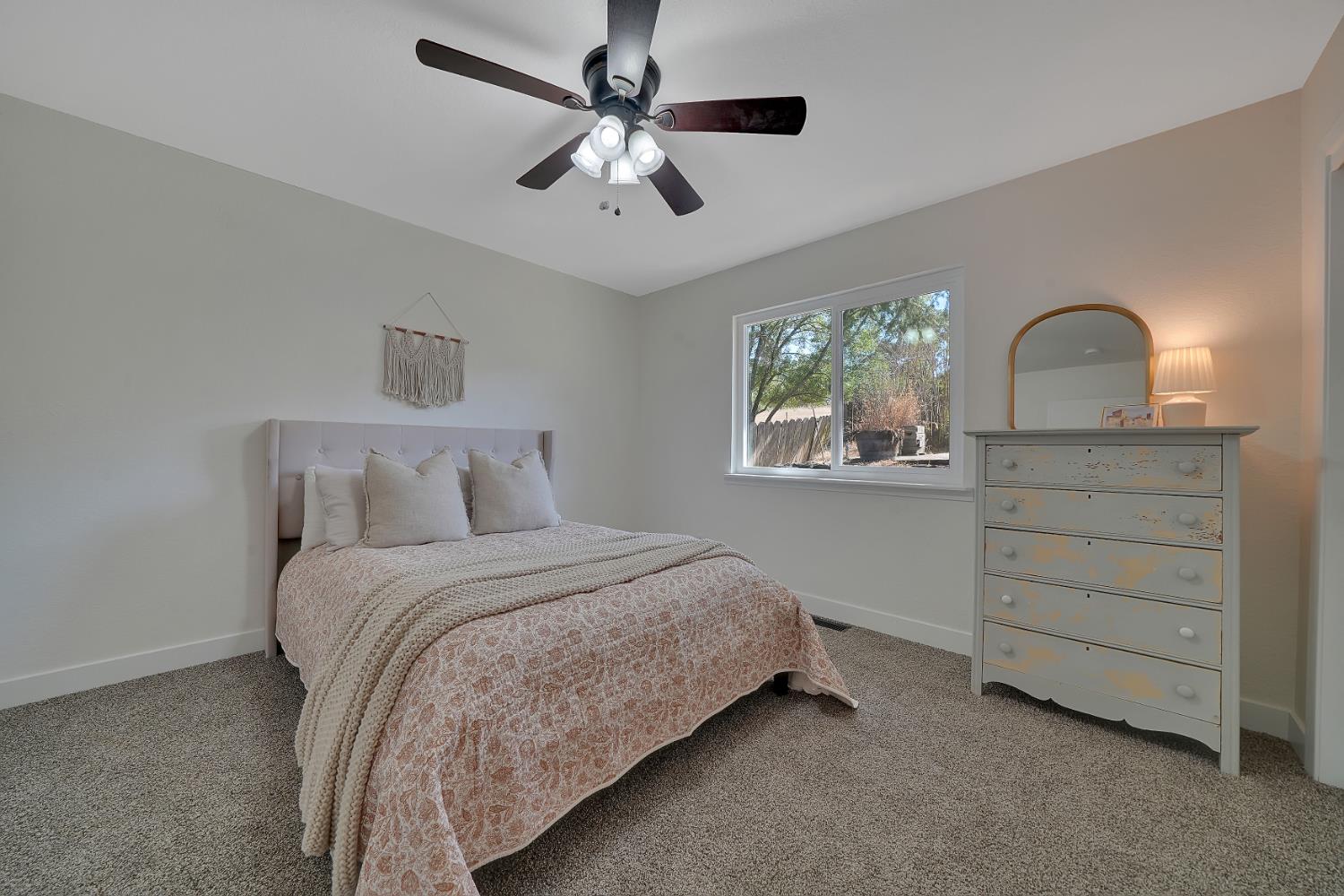 513 Perry Street Jackson, CA 95642 - Photo 36 of 56 a bedroom with a bed and a dresser