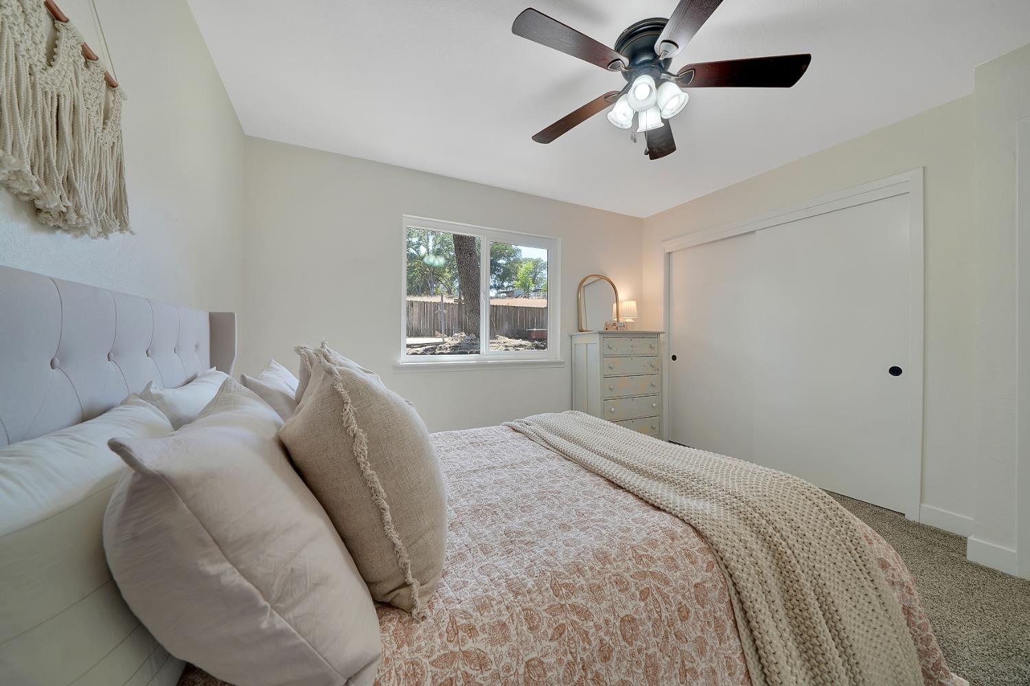 513 Perry Street Jackson, CA 95642 - Photo 37 of 56 a bedroom with a bed and a chandelier