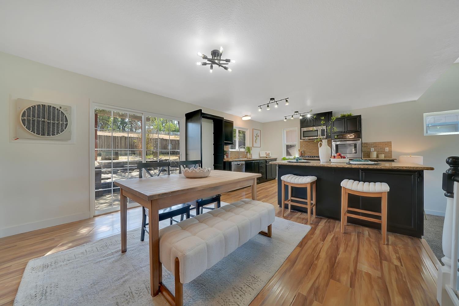 513 Perry Street Jackson, CA 95642 - Photo 7 of 56 a room with a table chairs and a kitchen view