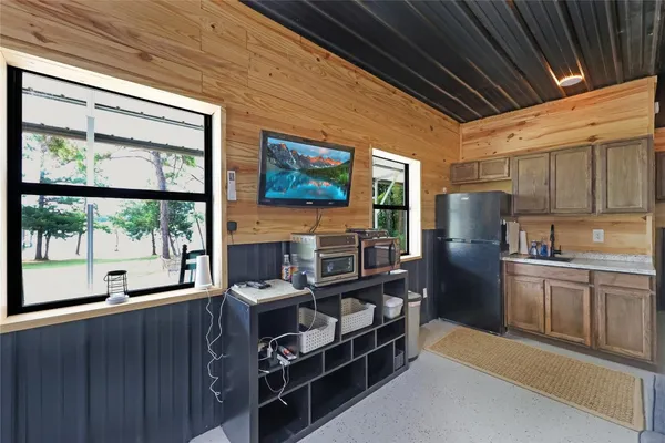 a kitchen with stainless steel appliances granite countertop a refrigerator and a stove