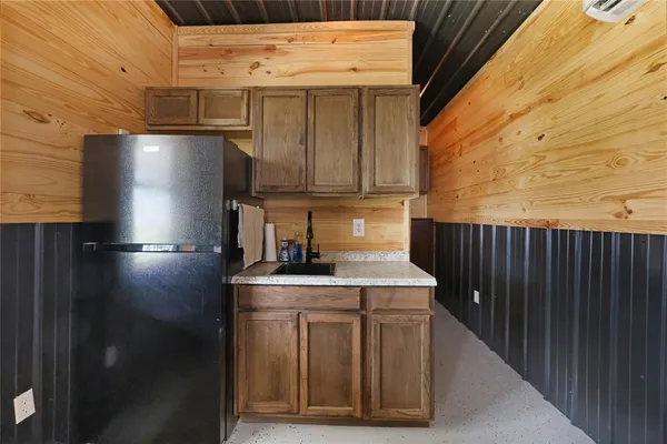 a kitchen with stainless steel appliances granite countertop a refrigerator a stove and a sink